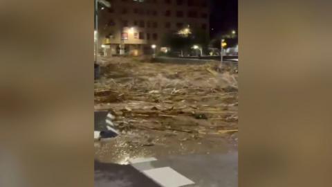 Flood waters gushing down street in Spanish town