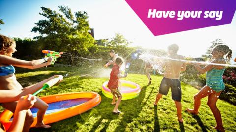 children having a water fight