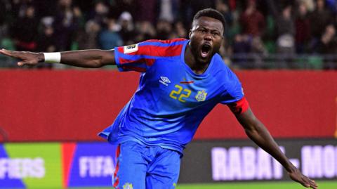 Chancel Mbemba celebrates scoring the winning penalty for DR Congo