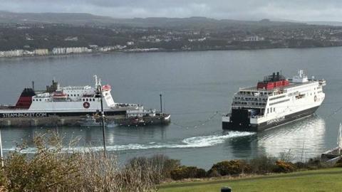 The Manxman ferry leaving Douglas Harbour with the Ben-My-Chree moored tot he left.