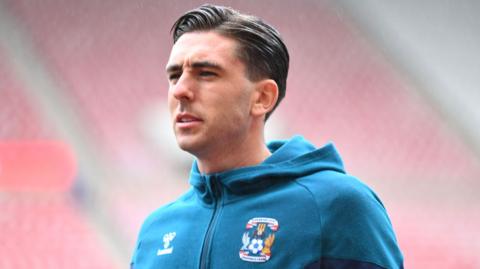 Luis Binks in his Coventry City hoodie arriving ahead of a match