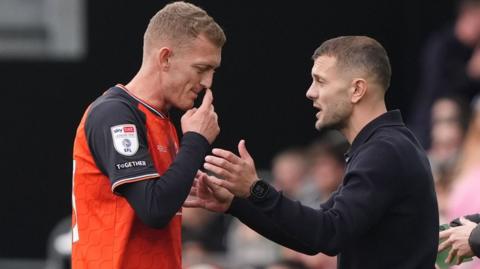 Luton Town manager Jack Wilshere talking to George Saville