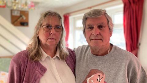 Picture taken of Gary and Alison Eden standing together in their home. 