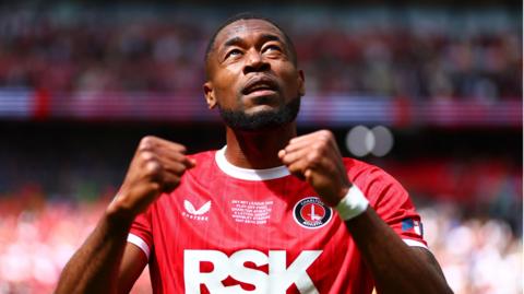 Chuks Aneke pumps both fists and looks to the sky in celebration after Charlton's victory in the League One play-off final at Wembley