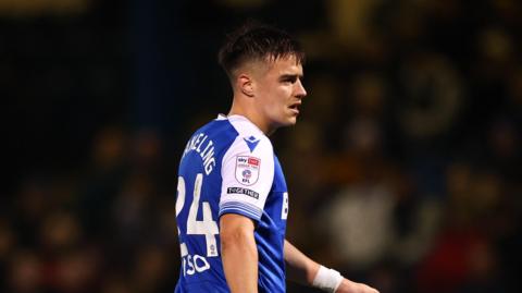 A side on shot of Jacob Wakeling playing for Gillingham last season, wearing a number 24 shirt 