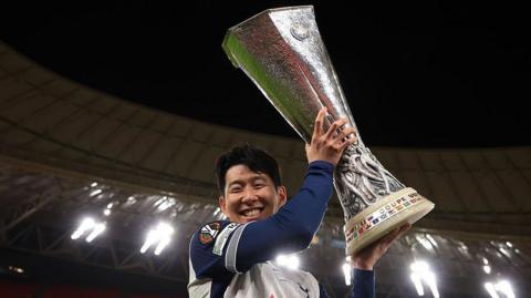 Tottenham captain Son Heung-min holds the Europa League trophy after his team's win against Manchester United in Spain