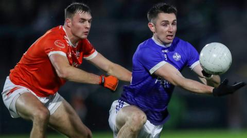 Clann Eireann's Daniel Magee challenges Clan na Gael's Shane McPartlan