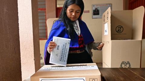 A Misak Indigenous woman casts her vote during the presidential election, at the Guambia Indigenous Reserve, Cauca department, Colombia