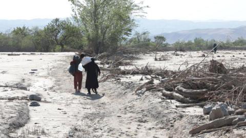 Civilians are seen after floods caused by heavy downpour as more than 300 were killed and tens of others have gone missing in Baghlan, Afghanistan on May 16, 2024