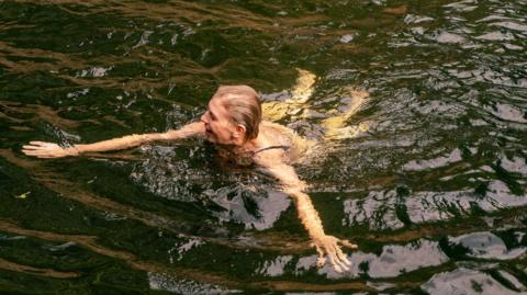 A woman swimming in river