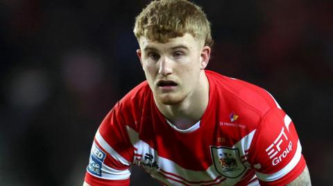 George Delaney in action for St Helens in their red and white home shirt
