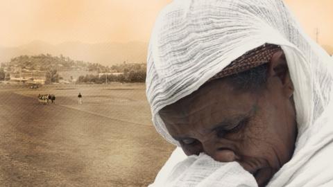 A composite image of an elderly woman in a white headscarf wiping away a tear with an outdoor athletics track in the background