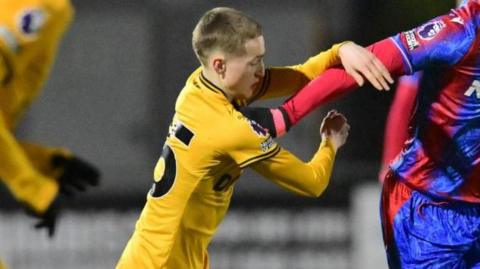 Finn Ashworth challenges Crystal Palace's Malcom Ebiowei playing for Wolves Under-21s in a Premier League 2 game in January