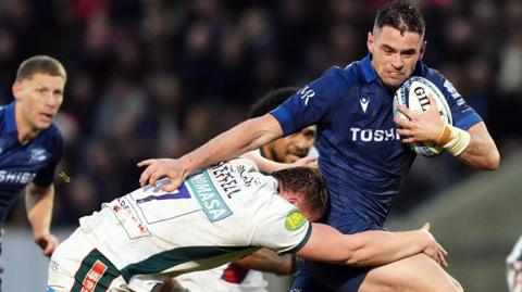 Sale Sharks Luke James is tackled by Leicester Tigers' Tommy Reffell