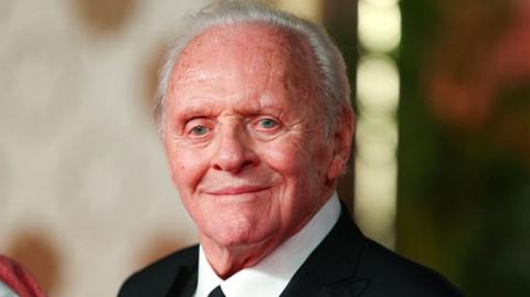 Sir Anthony Hopkins in a dark suit and tie