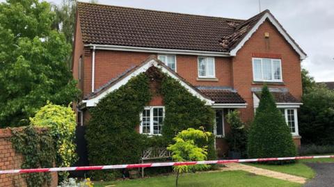 House with roof damage after being struck by lightning