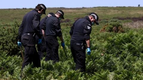 Police officers investigate the area near the home of 78-year-old former government minister Ann Widdecombe.