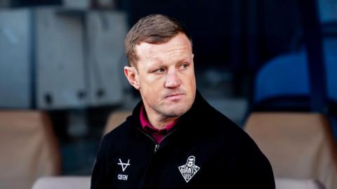 Luke Robinson, then head coach of Huddersfield Giants, looks on from the touchline.