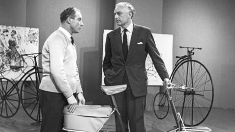 Reg Harris and Alex Moulton standing in a studio with some vintage bicycles