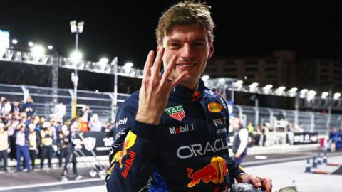 Max Verstappen holding up four fingers to represent his world titles