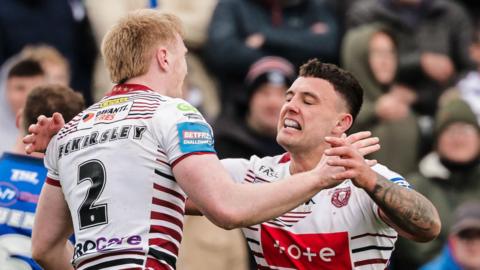 Zach Eckersley is congratulated by Wigan team-mate Oliver Partington after scoring a try