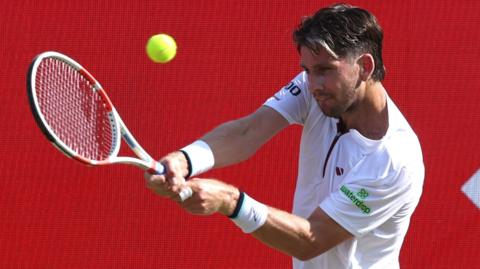 Cameron Norrie hits a backhand