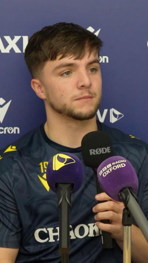 Tyler Goodrham behind some microphones.