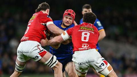 Josh van der Flier of Leinster in action against Scarlets players Max Douglas, left, and Fletcher Anderson