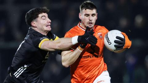 Armagh's Greg McCabe is challenged by James Guinness