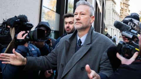 Nathan Gill surrounded by press cameras outside Old Bailey