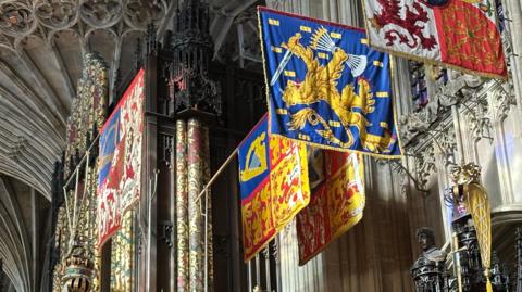 Royal banners hang in the grandeur of the chapel
