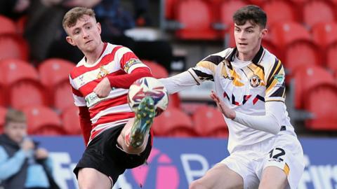 Joe Thomas of Newport and James Maxwell of Doncaster Rovers