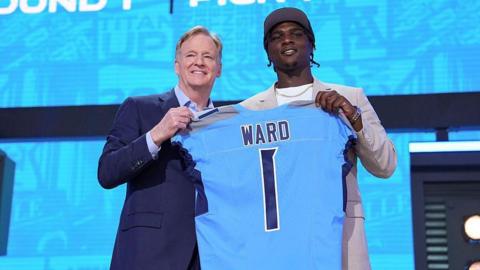Cam Ward holding a Tennessee Titans shirt during the 2025 NFL draft