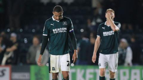 Brendan Galloway with his head down