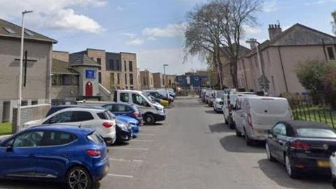 A street with car parking spaces on both sides 