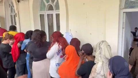 Image shows the suspects arrested after a raid on a call centre operating in the city of Faisalabad, Pakistan