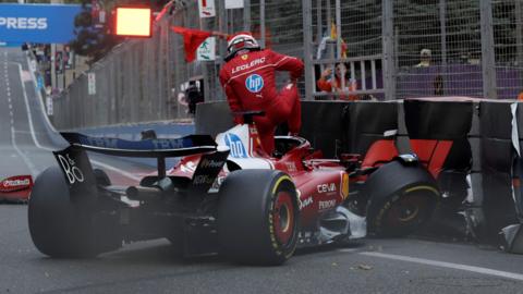 Ferrari's Charles Leclerc climbs out of his car after crashing into the barriers during qualifying for the Azerbaijan Grand Prix