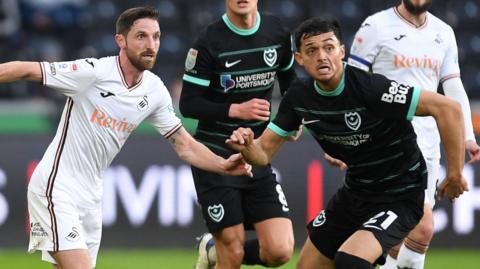 Swansea's Joe Allen battles with Portsmouth's Andre Dozzell