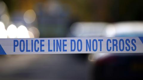 Tape. Text reads: 'POLICE LINE DO NOT CROSS'