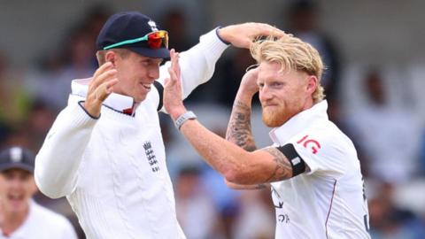 Ben Stokes celebrates a wicket with Zak Crawley, both men are high-fiving