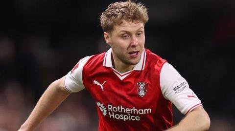 Jamie Lindsay running on the field during a Rotherham match