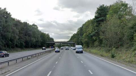 A street view image of the A46. Cars are driving on each side of the road