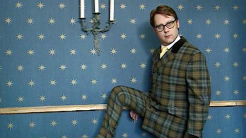 Comedian Vic Reeves wearing one of his recognisable plaid suits.
