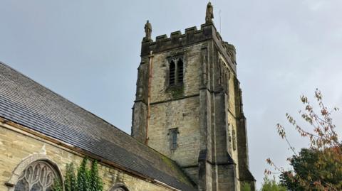 A view of St Paul's in Truro showing a stone church tower and part of the building's roof 