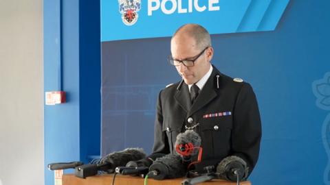 Assistant Chief Constable Matt Longman behind podium.