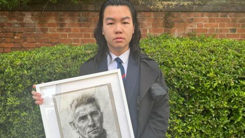 Andy with his portrait of Kieran McKenna