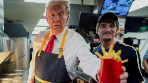 Donald Trump holding some fries in a McDonald's 