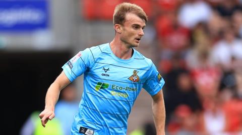 George Miller running on the during a pre-season game for Doncaster