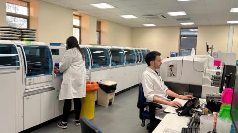 Two people working in a lab.