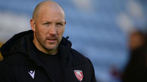 George Skivington walking on the pitch before a match